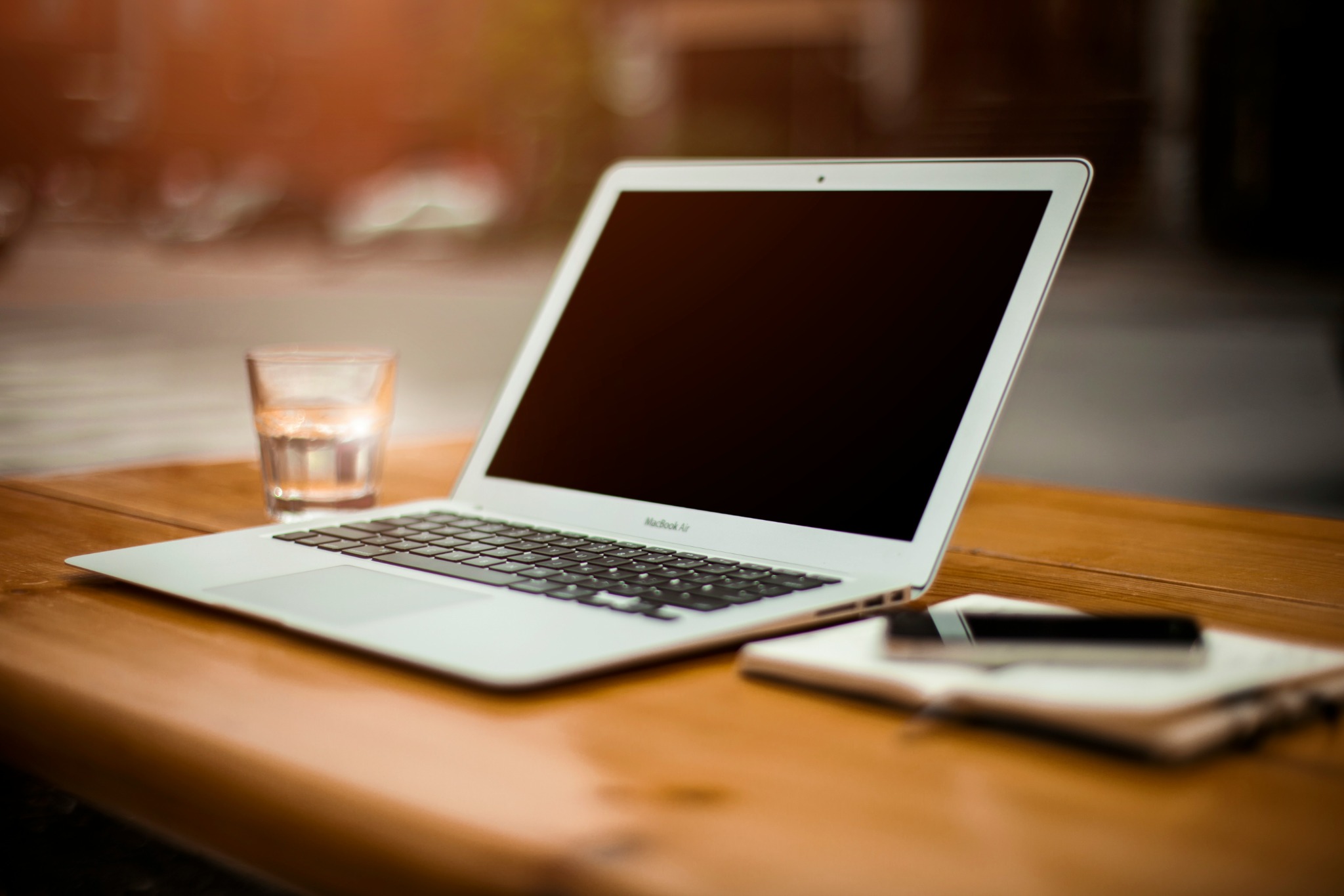 Laptop on a wooden desk — Michelle's Solutions web design project